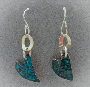 heart shaped metal earrings with blue patina