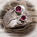 sterling ring with two faceted ruby gemstones